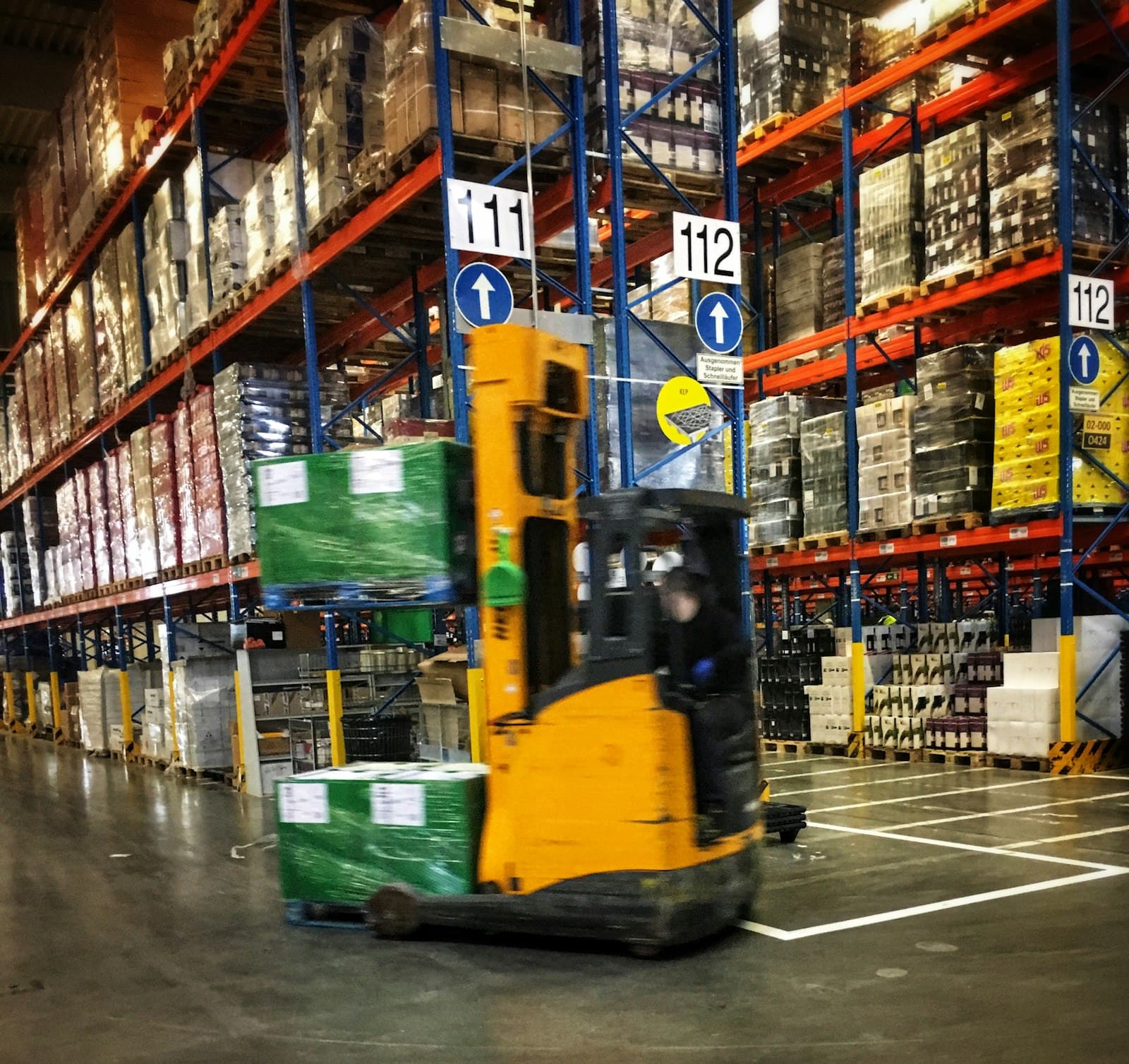 A forklift moving pallets in a warehouse